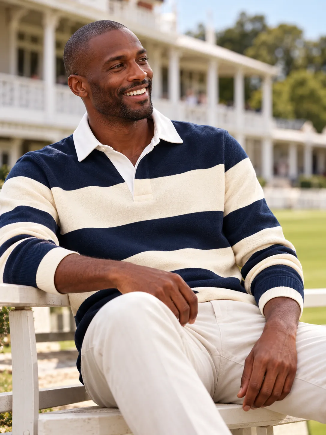 Smiling man in a navy and cream striped rugby shirt